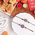/images/pr/canada/l/v20240704142926/vibrant-ganesh-and-om-rakhi-duo-n-milk-cake-delight_1.jpg