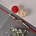 /images/pr/l/v20220705185522/sneh-diamond-studded-pearl-rakhi_1.jpg