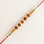 /images/pr/l/v20240628174835/celestial-charms-rudraksha-rakhi-n-almond-soan-papdi-gift-set_7.jpg