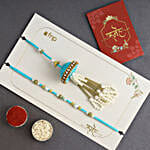 /images/pr/spain/l/v20240711131656/tranquil-teal-jhumar-bhaiya-bhabhi-pearl-rakhi-set-n-sweet-treats_2.jpg