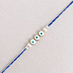 /images/pr/uae/l/v20240722180734/simplistic-blue-evil-eye-rakhi_3.jpg