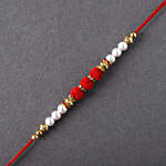 /images/pr/uk/l/v20220707124445/sneh-white-pearls-rakhi-with-sweet-treats_2.jpg