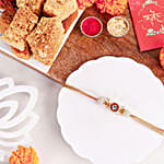 /images/pr/uk/l/v20240712171811/crimson-majestic-pearl-rakhi-n-milk-cake-delight_1.jpg