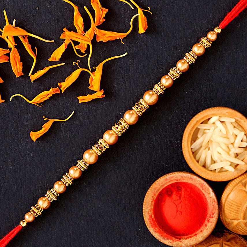 Traditional Pearl Mauli Rakhi And Healthy Almonds