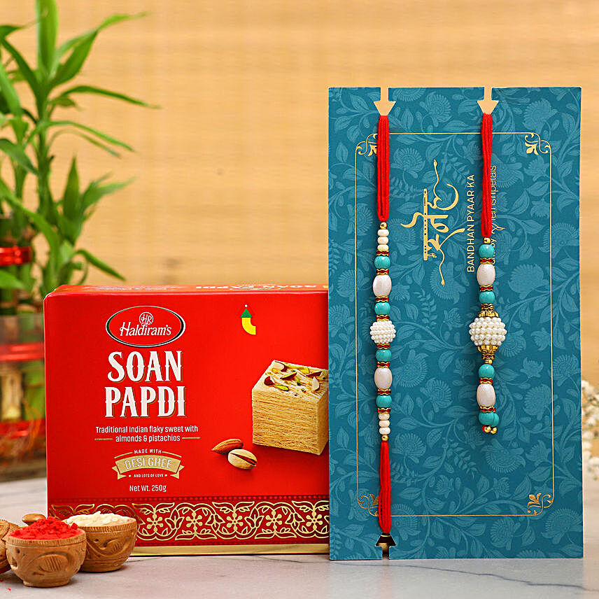 Blue Pearl And Lumba Rakhi Set With Soan Papdi:Rakhi Delivery for Bhaiya Bhabhi in Brazil