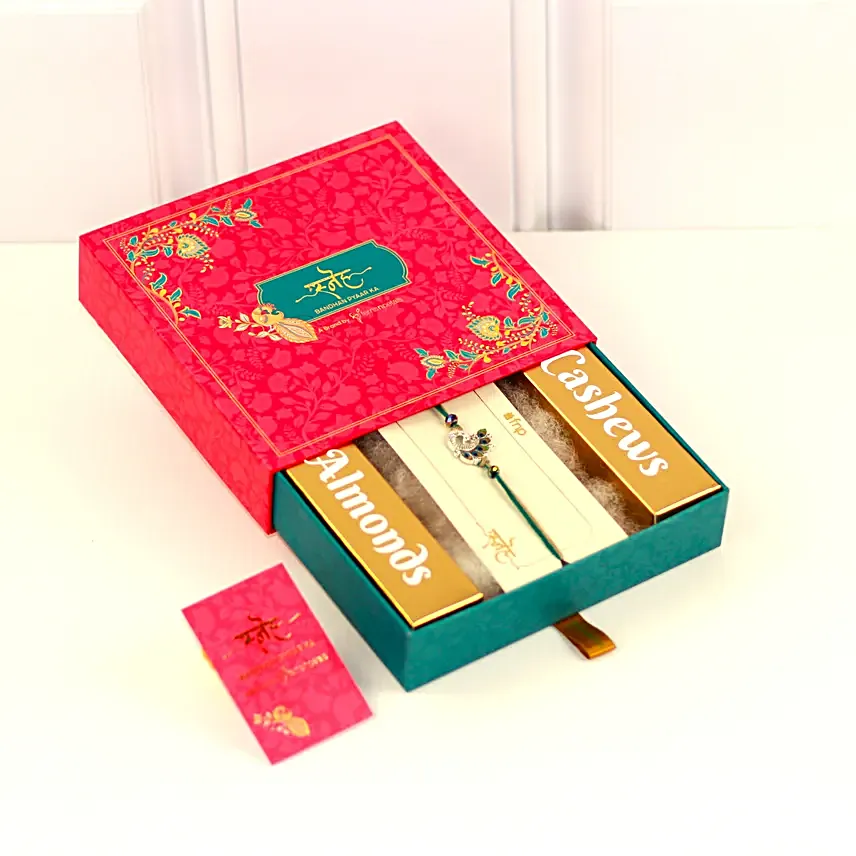 Alluring Peacock Rakhi and Nut Treats