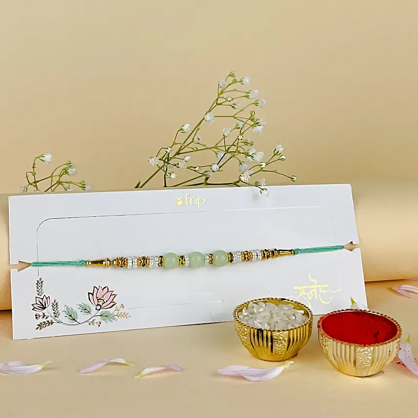 Tranquil Pearls Rakhi N Ganesha Blessings Idol
