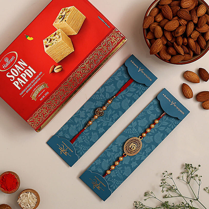 Om And Lion Face Rakhis With Soan Papdi And Almonds