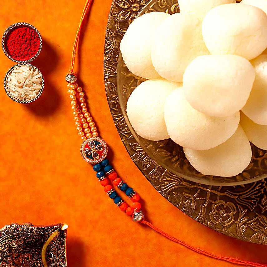 Sneh Designer Peach Rakhi & Rasgullas:Rakhi and Sweets to Germany