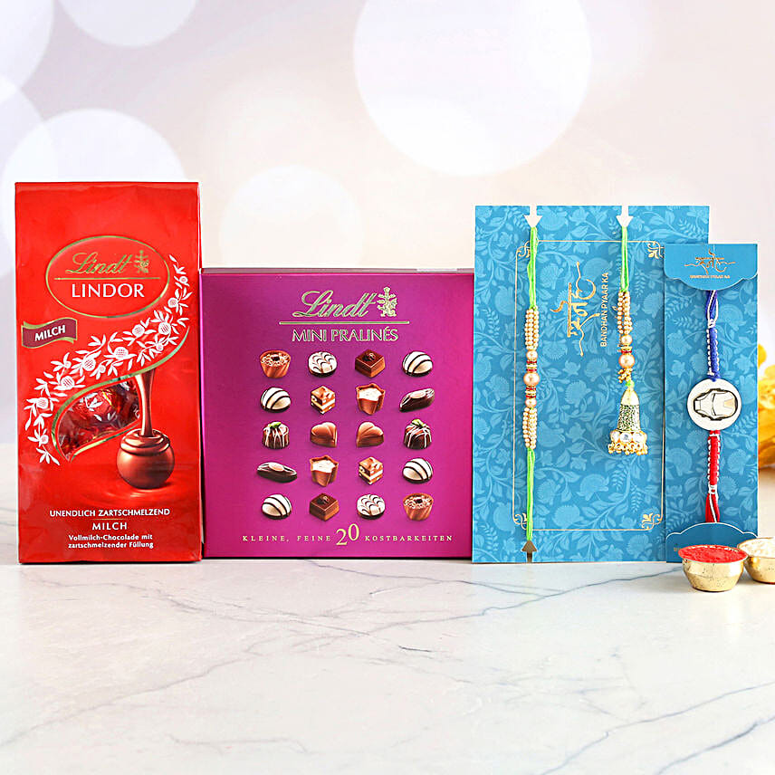 3 Designer Rakhis And Delectable Chocolate Hamper