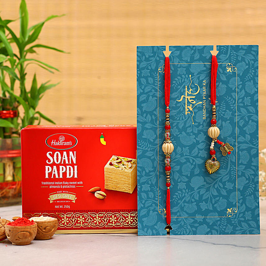 Red Pearl And Lumba Rakhi Set With 250 Gms Soan Papdi