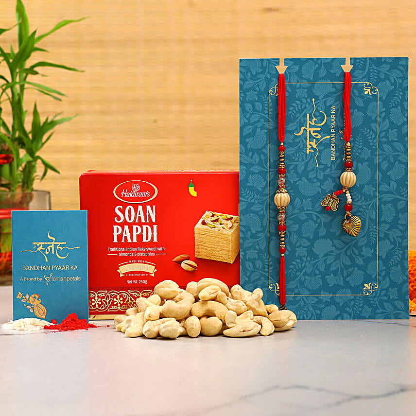 Red Pearl Lumba Rakhi Set And Cashew With Soan Papdi