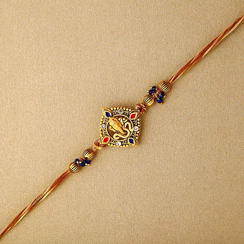 Celestial Ganesha Serenade Rakhi with Channa Barfi Combo
