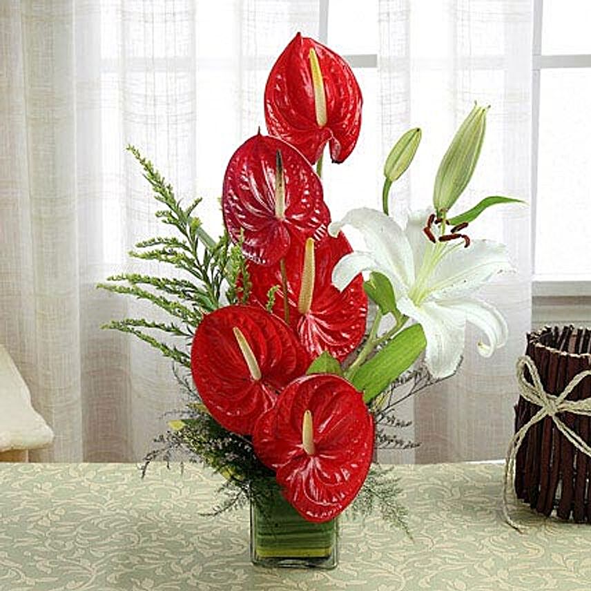Square glass vase arrangement of flowers:Anthuriums