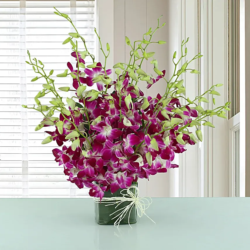 Exotic Expression - Arrangement of 20 purple orchids in glass vase.:Wedding Flowers for Bride