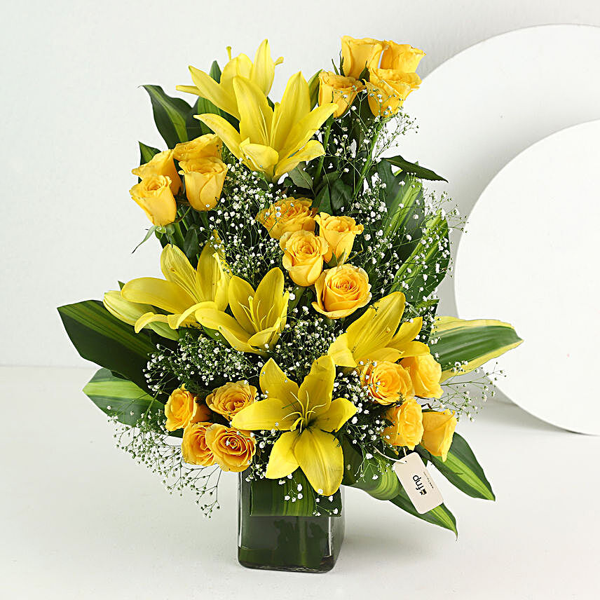 Glass vase arrangement of 20 yellow roses and 3 yellow asiatic lilies flowers gifts:Gifts To Gardanibagh, Patna