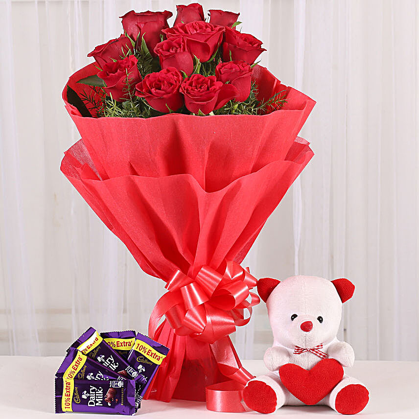 Cuddly Affair - bunch of 12 red roses with 6 inch teddy and 5 Cadbury Dairymilk .:Send Gift Baskets to Dehradun