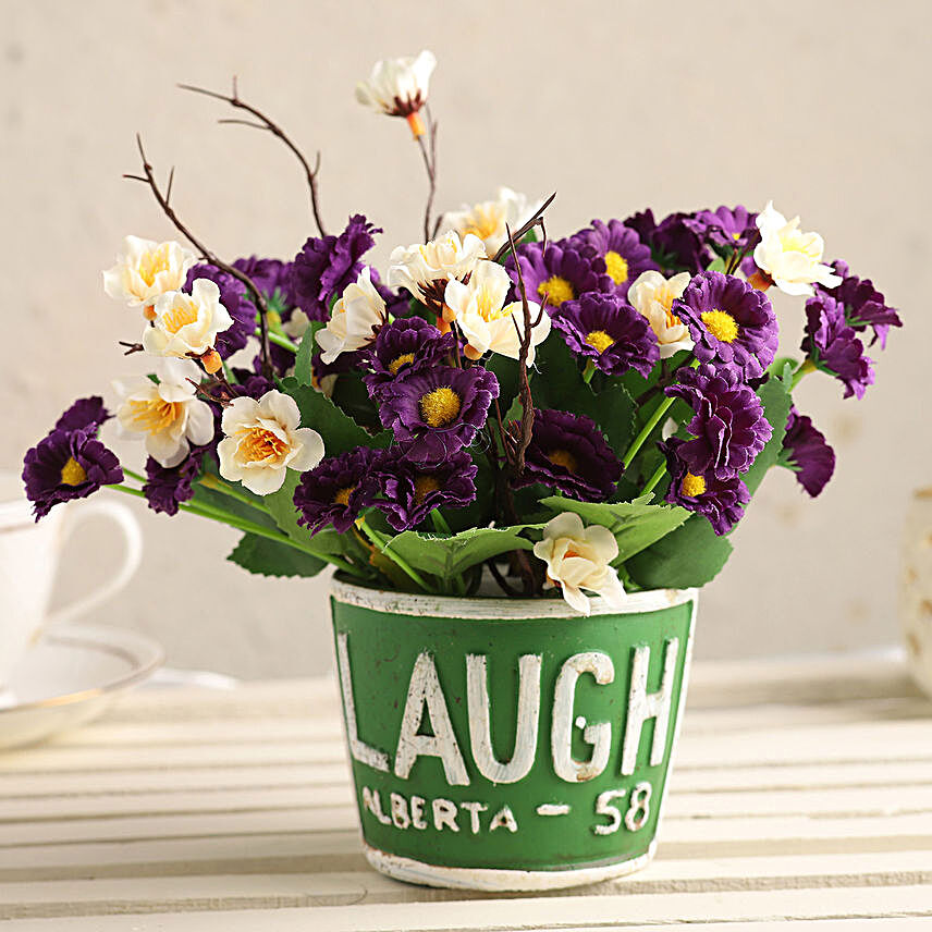 Purple & White Artificial Flowers In Green Pot