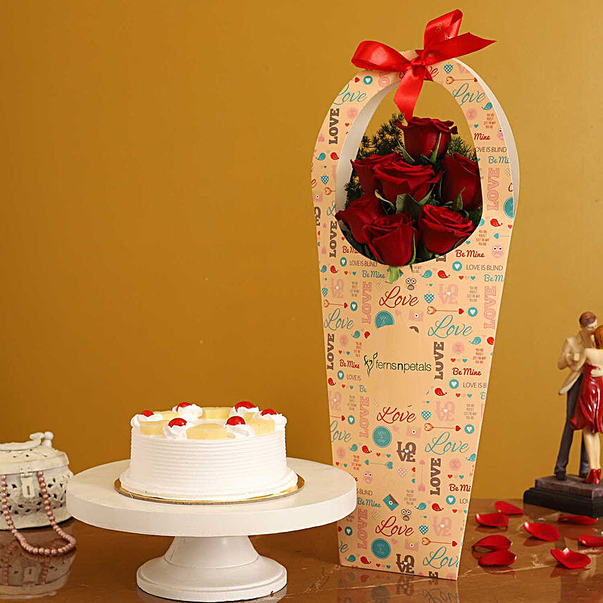 Pineapple Cake & Red Roses in FNP Love Sleeve:Cake And Flower Delivery In Hyderabad