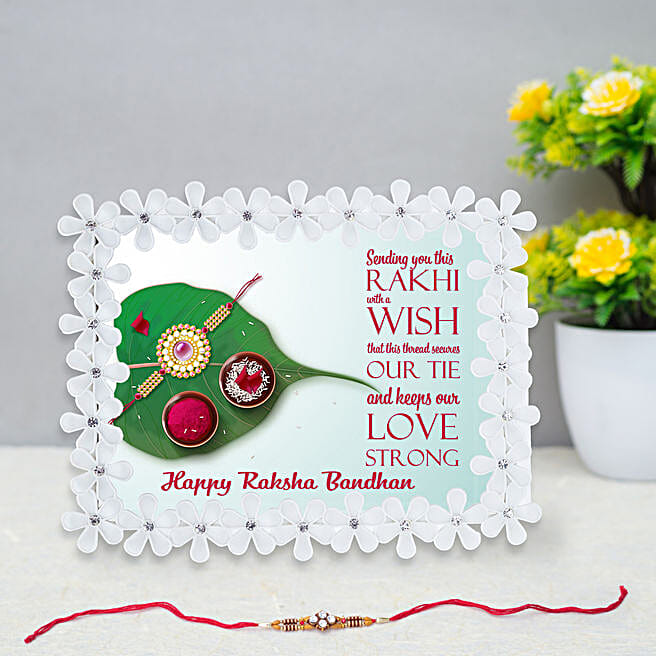 Buy/Send Traditional Rakhi and White Floral Frame Online- FNP