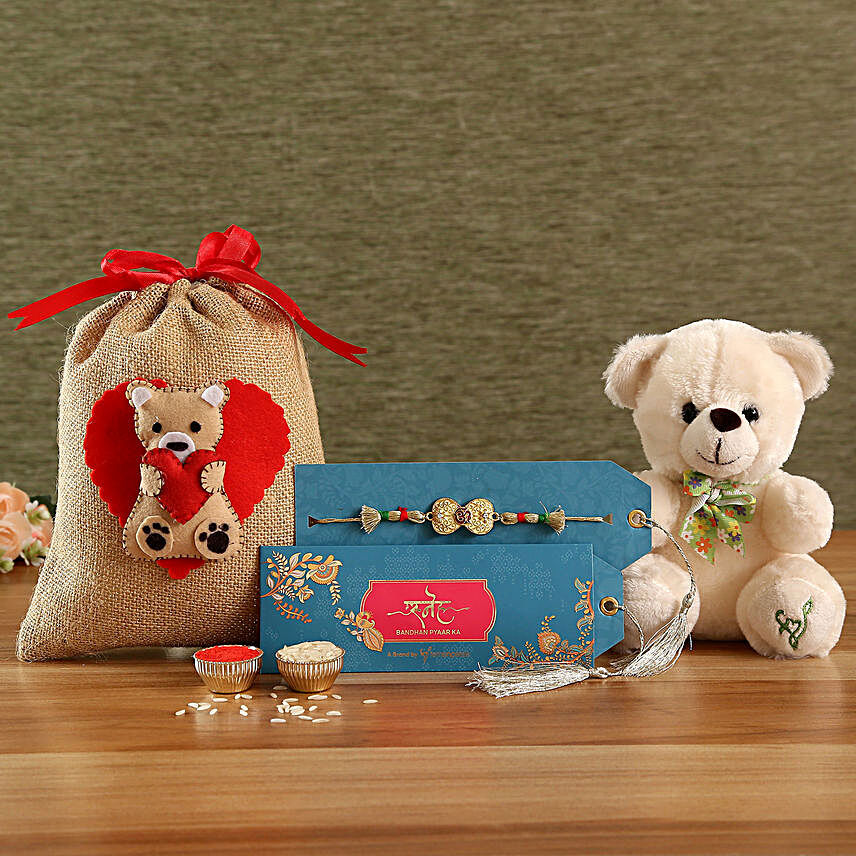 Buy/Send Om Rakhi & Beige Teddy In Cute Designer Potli Online- FNP