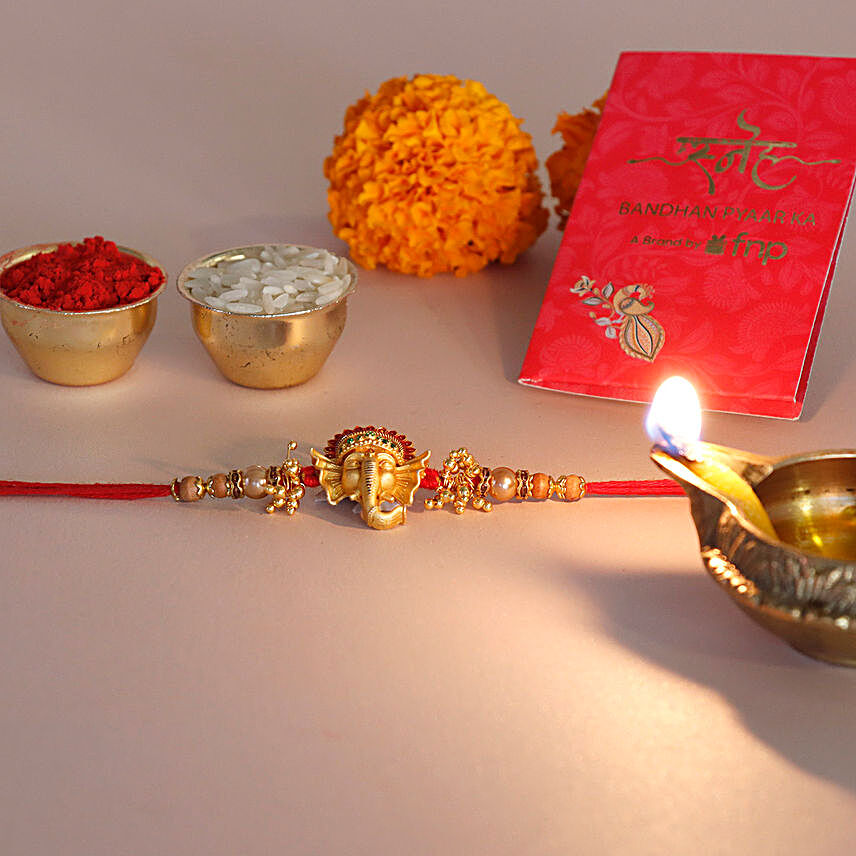 Sneh Golden Ganesha Face Rakhi and Ferrero Rocher
