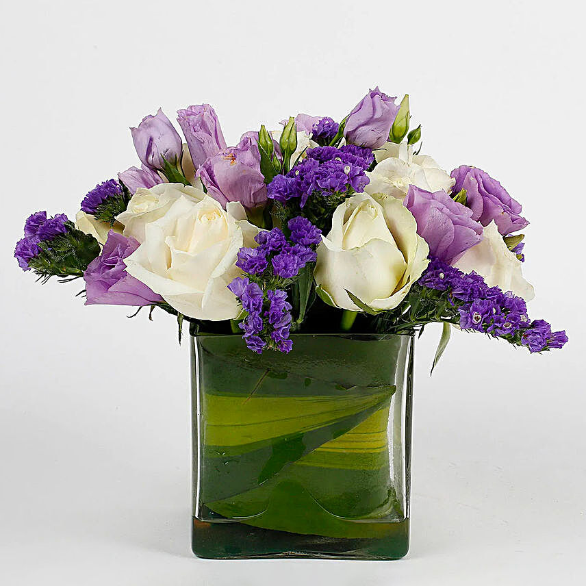 Fascinating White Roses & Purple Statice Flowers Glass Vase