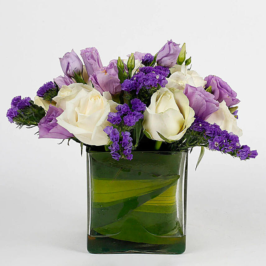 Fascinating White Roses & Purple Statice Flowers Glass Vase