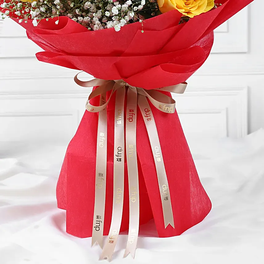Multicoloured gulal packets, red rose bouquet, gujia hamper