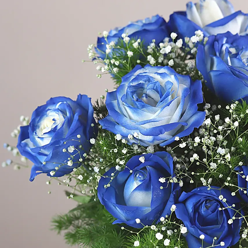 exotic blue shade roses in glass vase arrangement