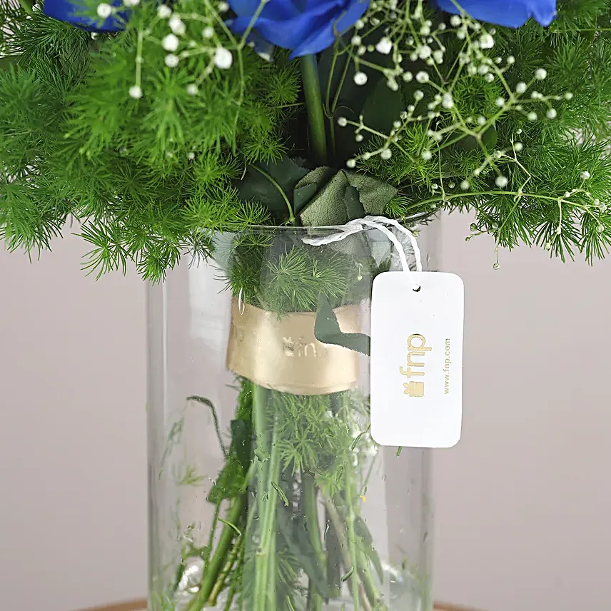 exotic blue shade roses in glass vase arrangement