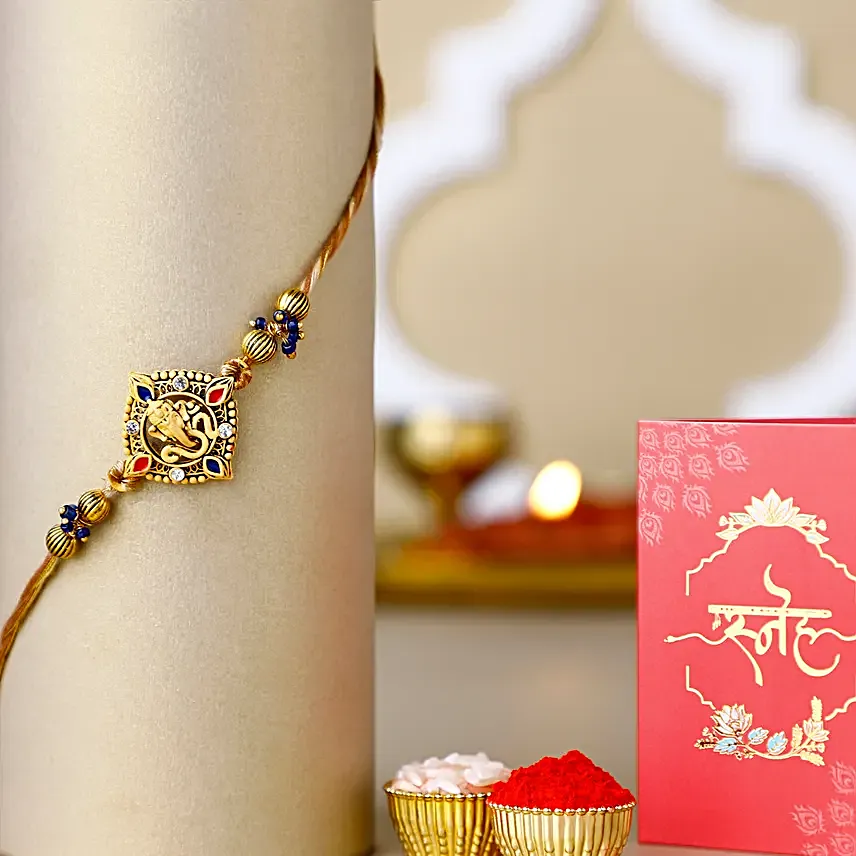 Celestial Ganesha Serenade Rakhi with Channa Barfi Combo