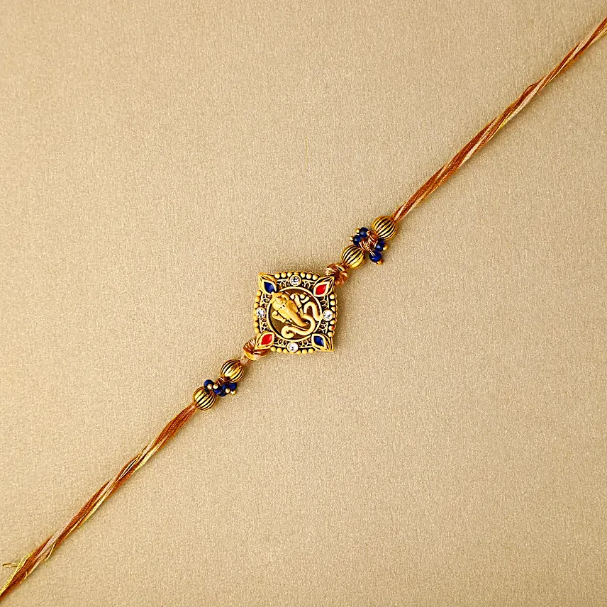 Celestial Ganesha Serenade Rakhi with Channa Barfi Combo