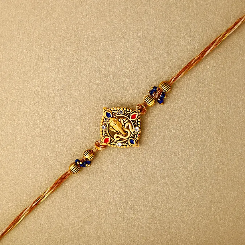 Celestial Ganesha Serenade Rakhi with Channa Barfi Combo