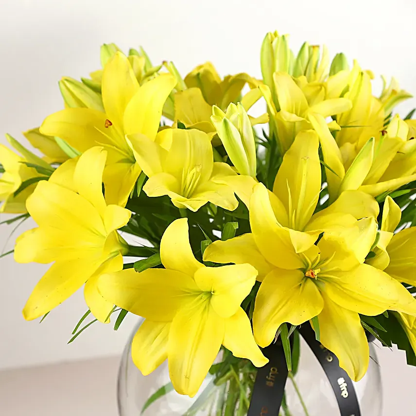 Cheerful Yellow Color Lilies In Fishbowl Vase