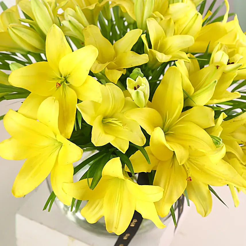 Cheerful Yellow Color Lilies In Fishbowl Vase