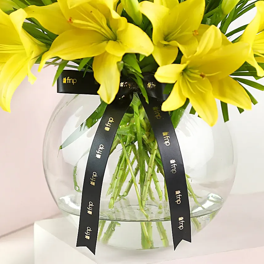 Cheerful Yellow Color Lilies In Fishbowl Vase