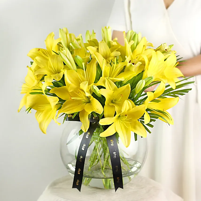 Cheerful Yellow Color Lilies In Fishbowl Vase