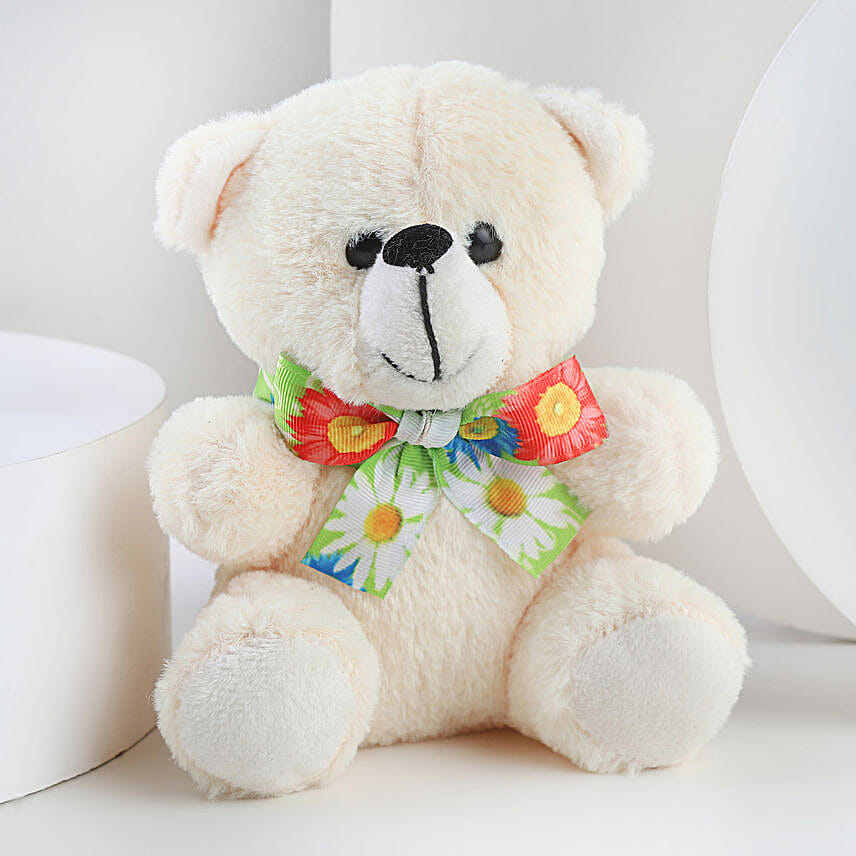 A hamper containing table top, dairy milk , cream teddy bear and a love message gifts
