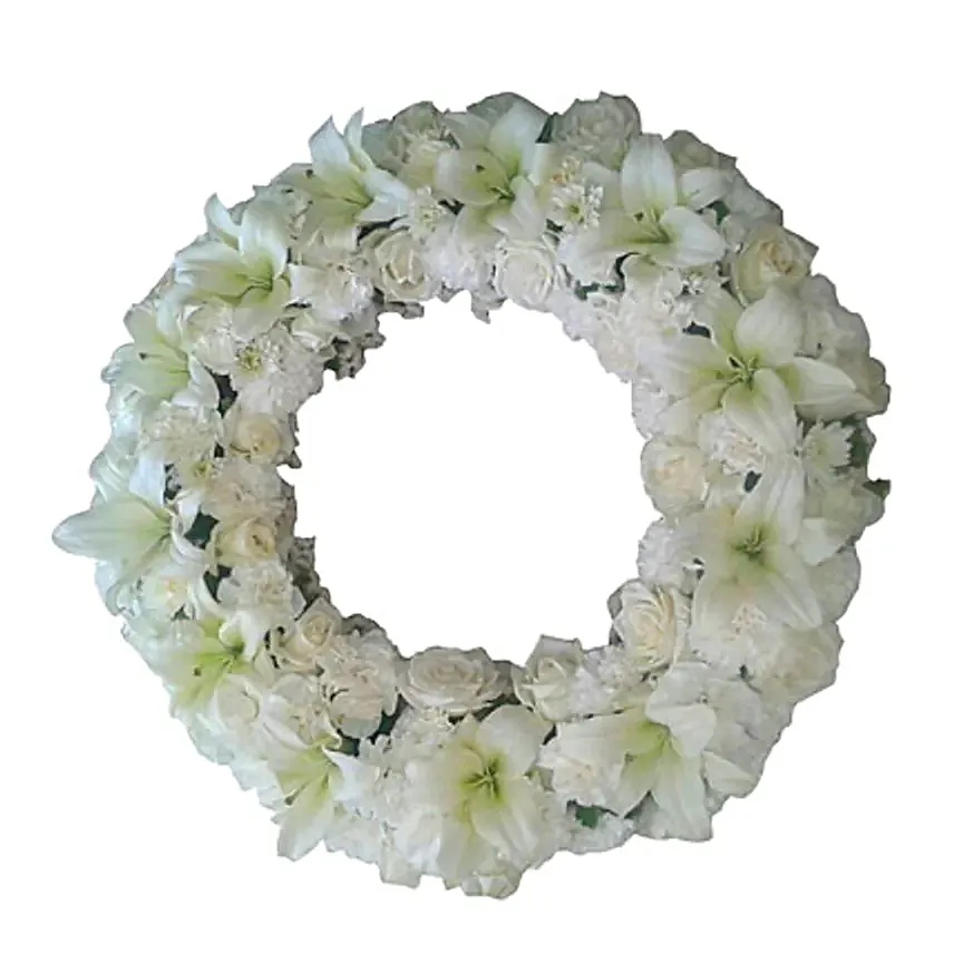 A fresh flower wreath with white roses, white carnations and white asiatic lilies