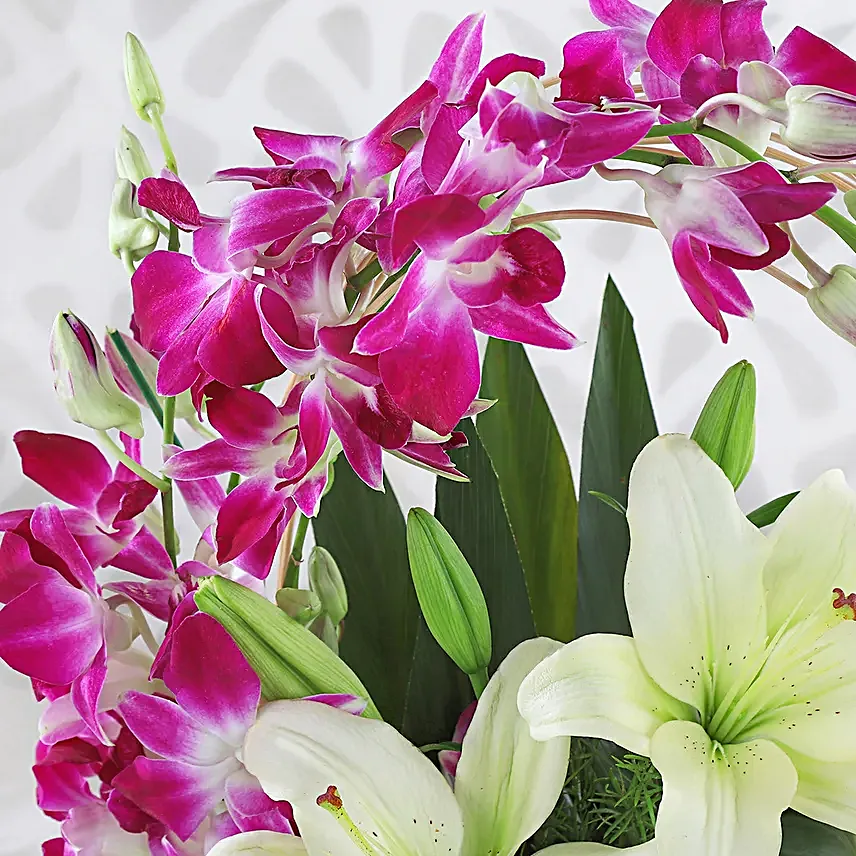 Always Works - Basket arrangement of 2 White asiatic lilies and 6 Purple Orchids.