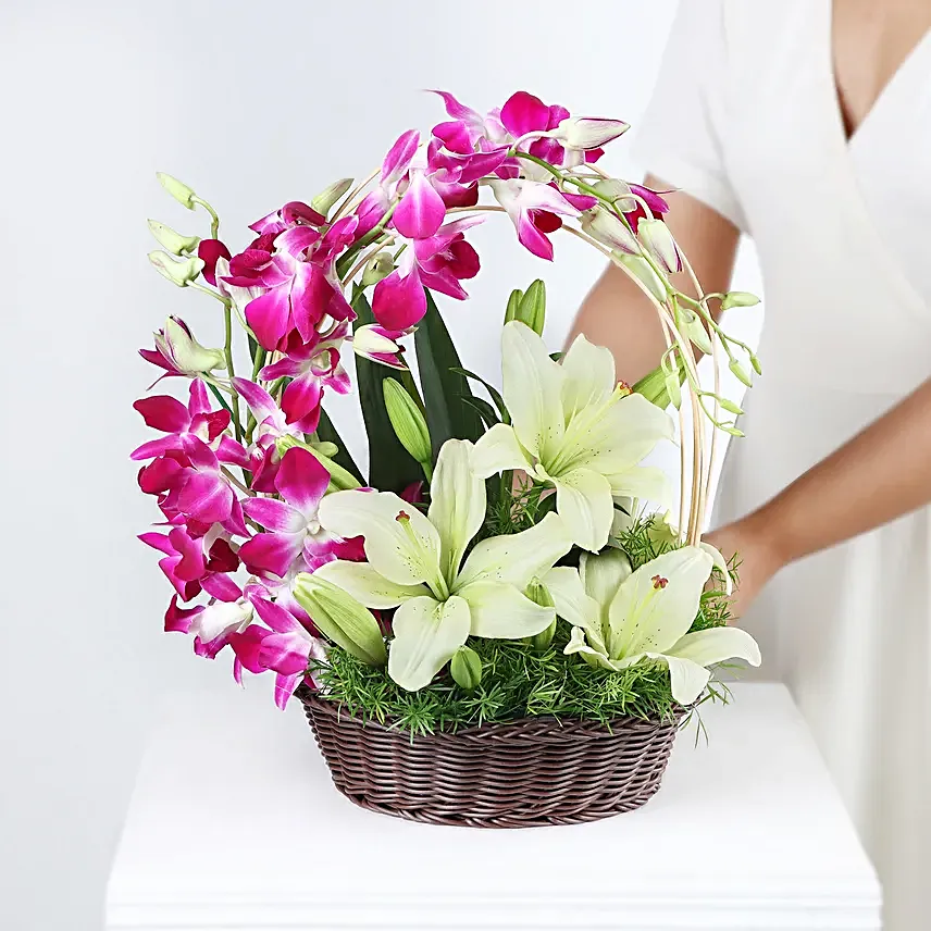 Always Works - Basket arrangement of 2 White asiatic lilies and 6 Purple Orchids.