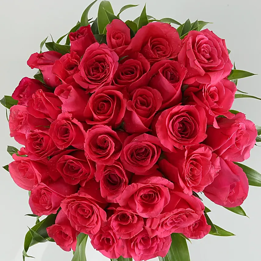 Love in the air - 30 pink roses are nicely arranged in a fish bowl glass vase.