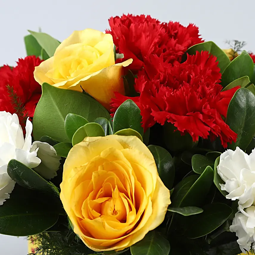 Mixed Carnations and Yellow Roses In Anniversary Vase