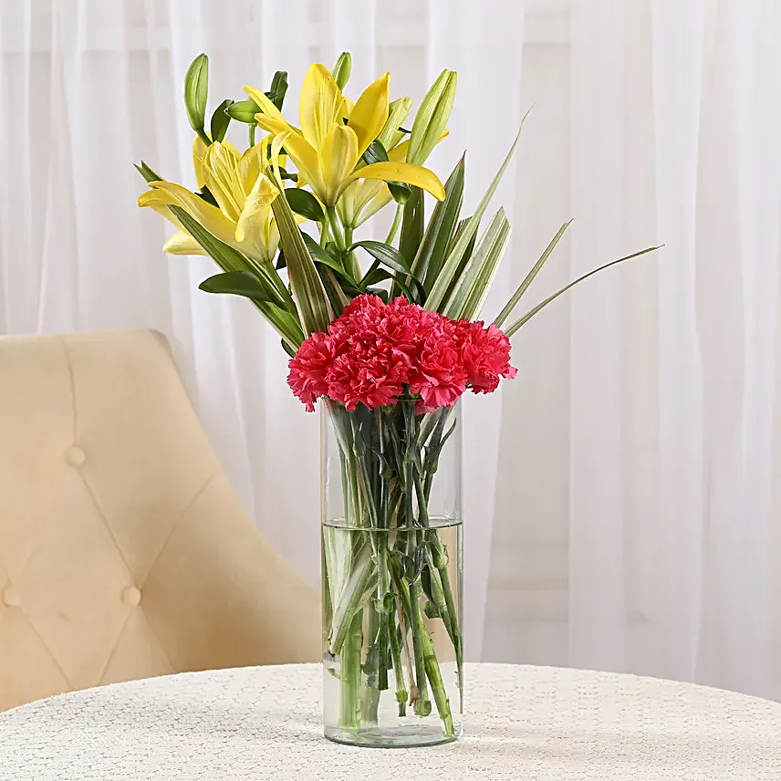 Orange Delight - Glass Vase arrangement of 6 orange carnations and 2 yellow lilies.