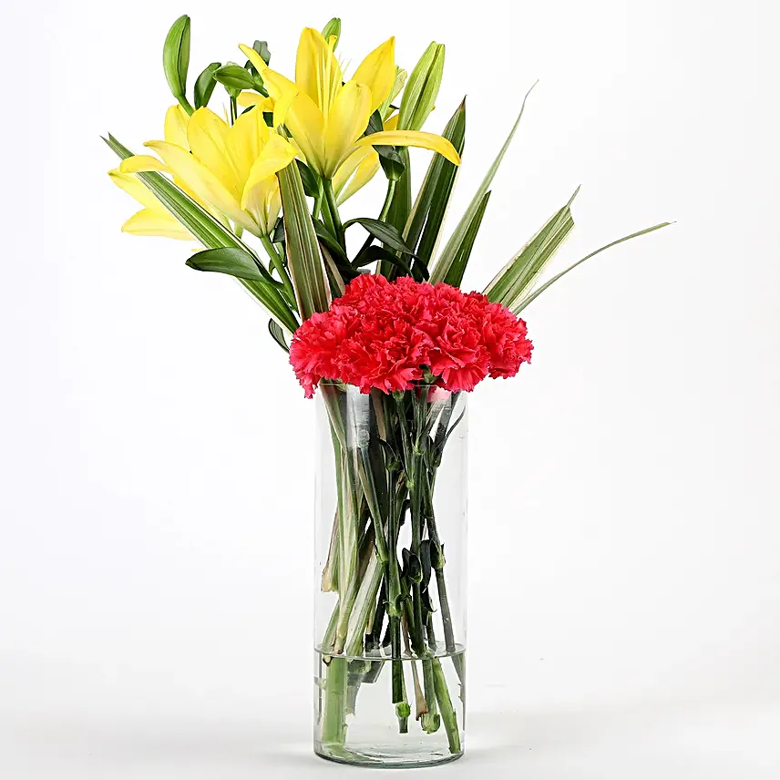 Orange Delight - Glass Vase arrangement of 6 orange carnations and 2 yellow lilies.