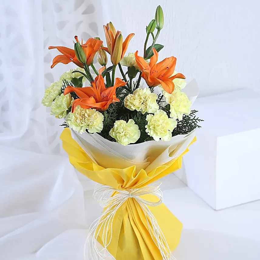 Radiance - Bunch of 10 yellow carnations 2 orange lilies in paper packing.