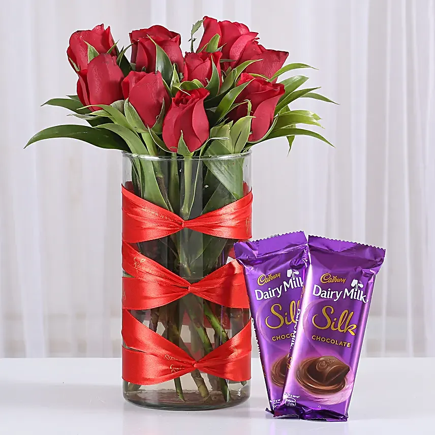 Roses in attractive vase with silk chocolates