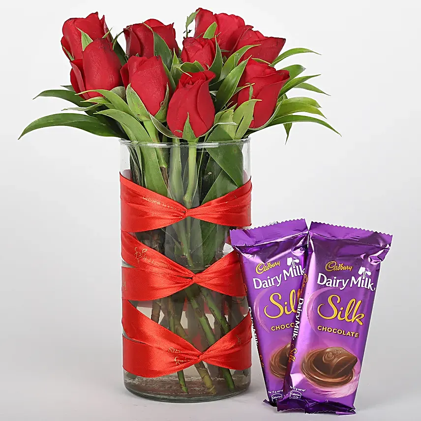 Roses in attractive vase with silk chocolates