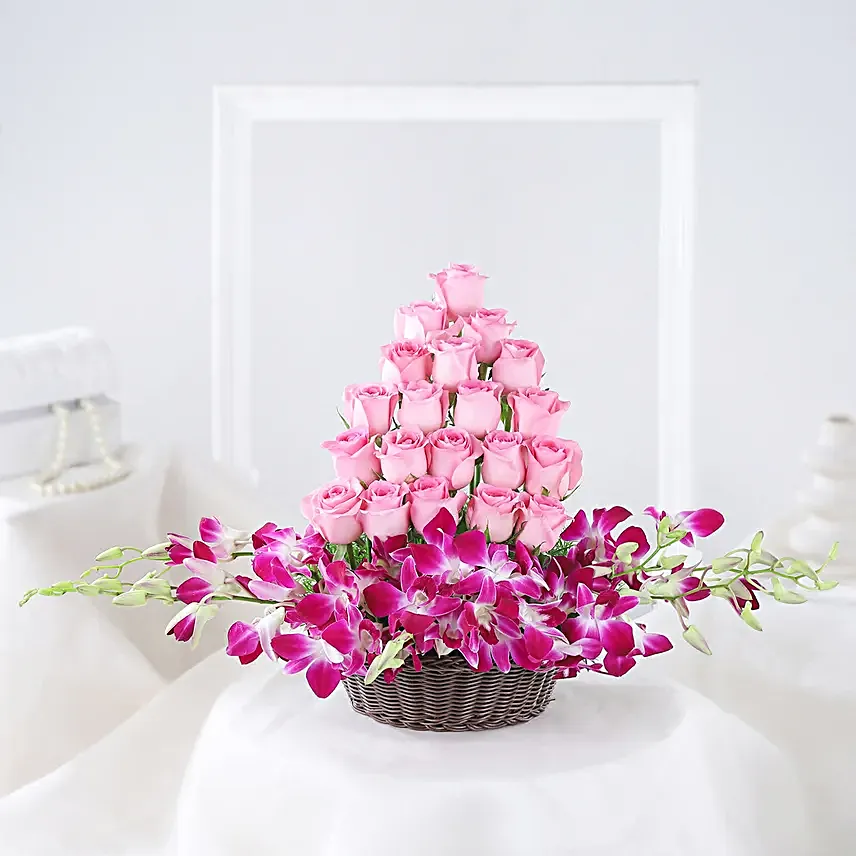 Cane Basket arrangement of 20 pink roses and 6 purple orchids